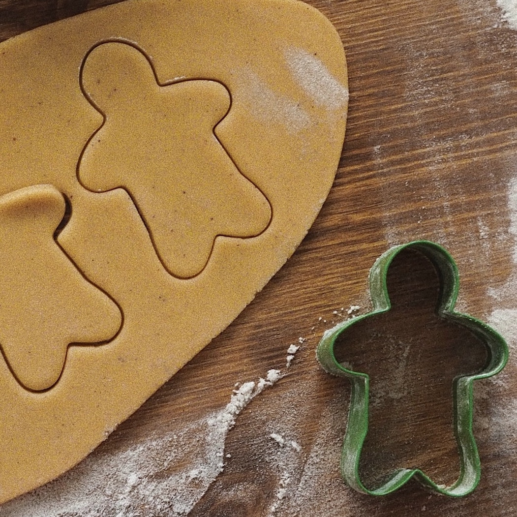 Cookies being cut with a cookie cutter